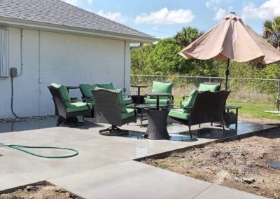 Slab, patio pour for an outdoor recreation and entertainiment area in Port Charlotte, FL with a sidewalk that goes to the shoreline, waters edge