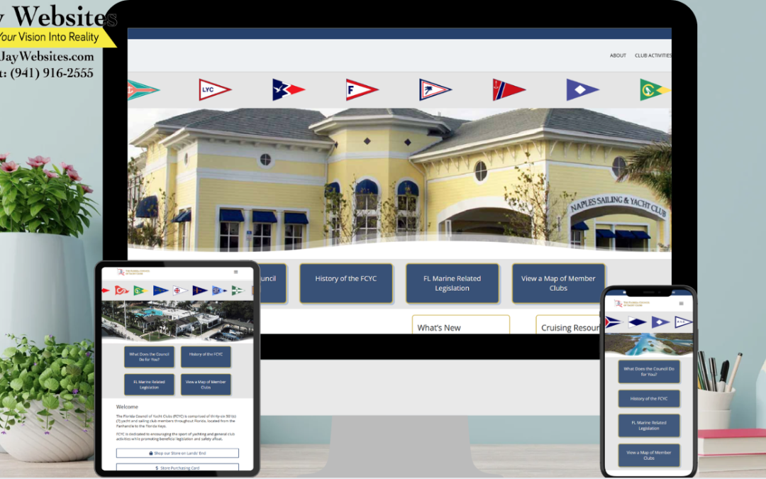 A desktop, tablet, and phone display a yacht club website with a yellow building on the homepage, on a desk with pink flowers. ;part of a website strategy, design & SEO system
